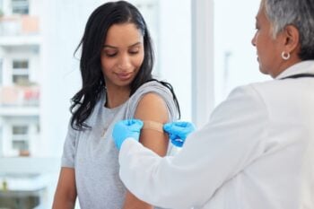 a woman getting a vaccination before traveling abroad