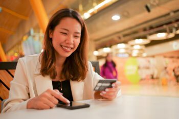 young woman researching the travel insurance available to her through her credit card