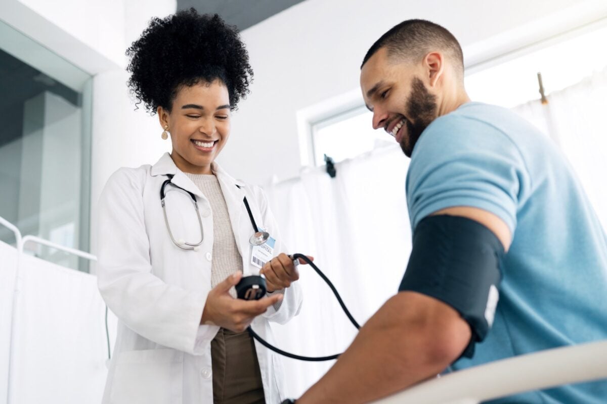 a male patient getting his blood pressure checked by a doctor in one of the many countries with universal healthcare