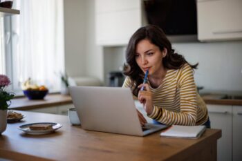 a woman using her laptop to review her health insurance plan