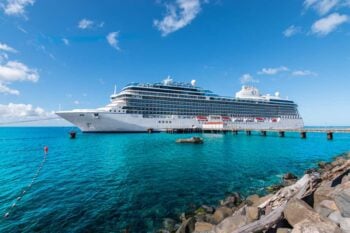 Oceania Vista cruise ship docked in Roseau, Dominica, where passengers are enjoying their trip having read the best cruise tips