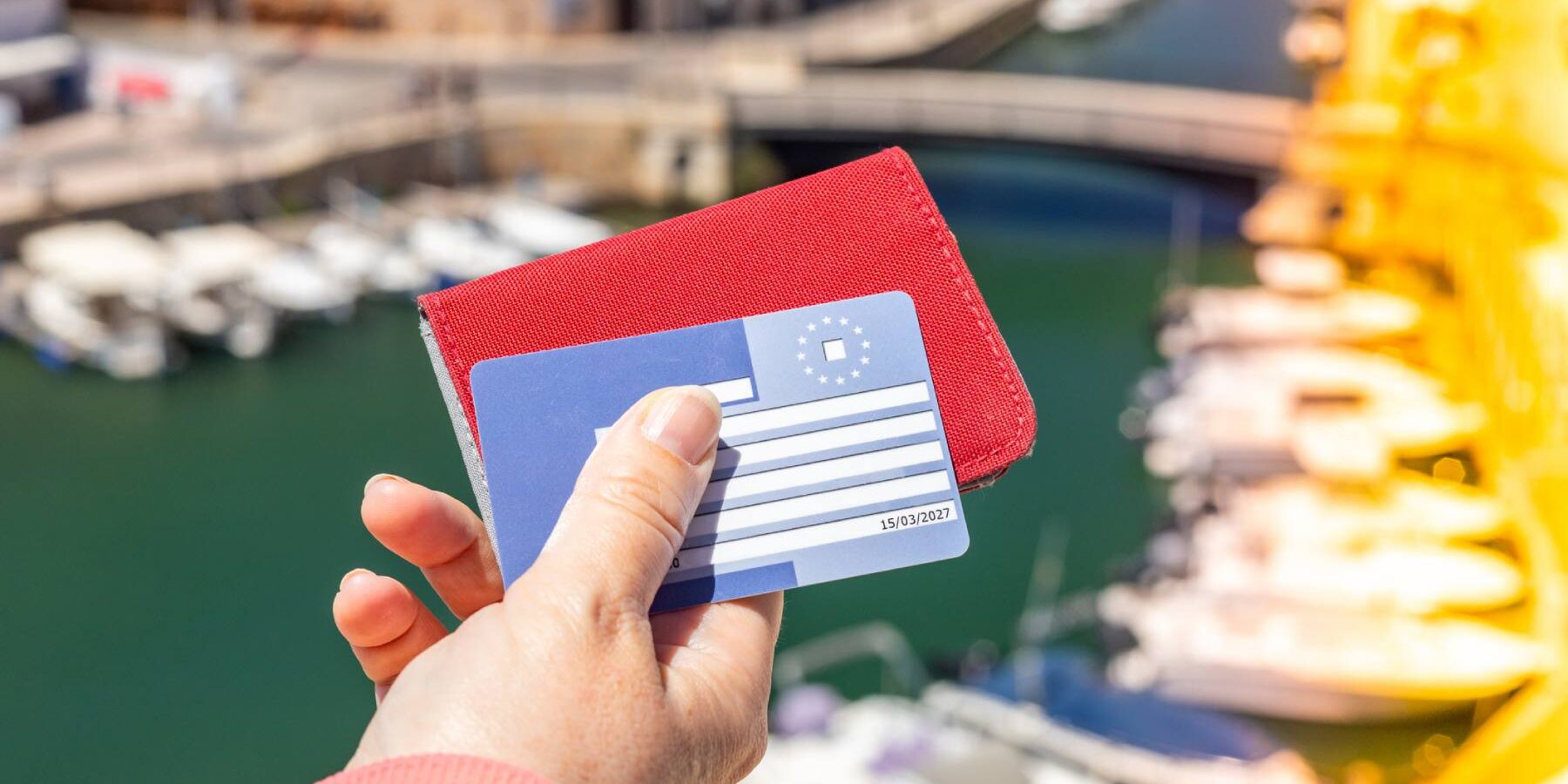 A woman holding a European health insurance card (EHIC) to access healthcare in the European Union and EFTA countries