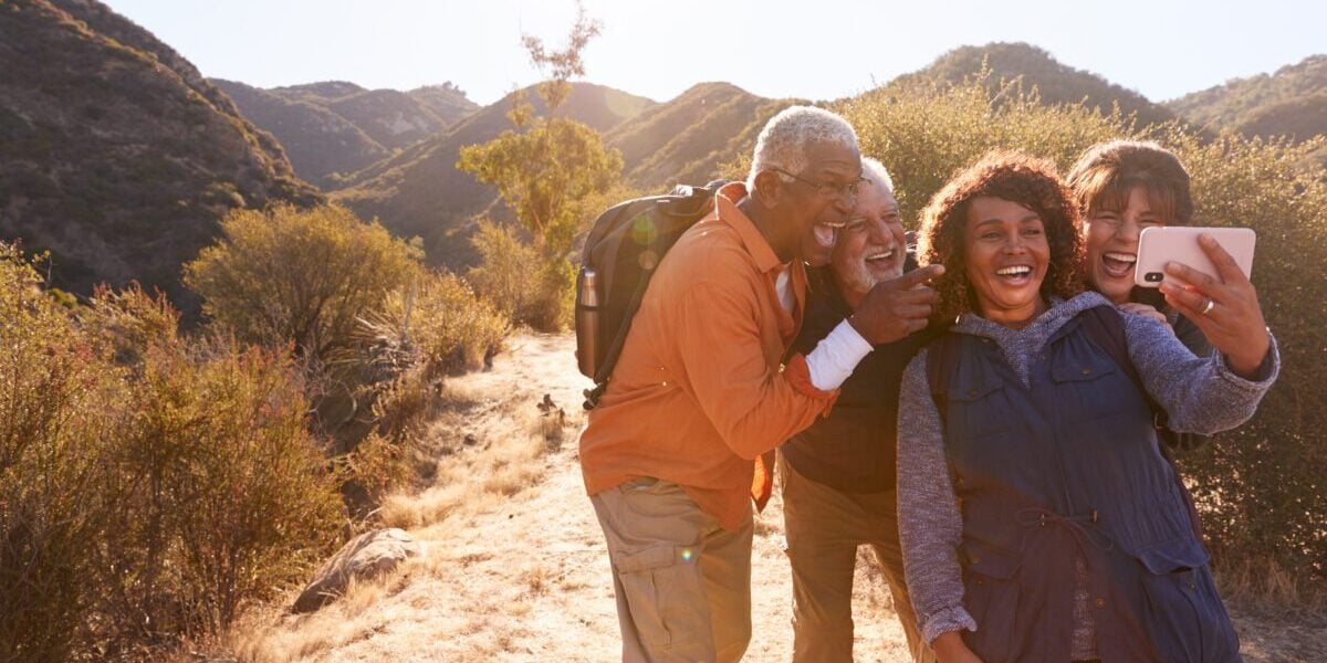 group of senior friends on a hike while traveling