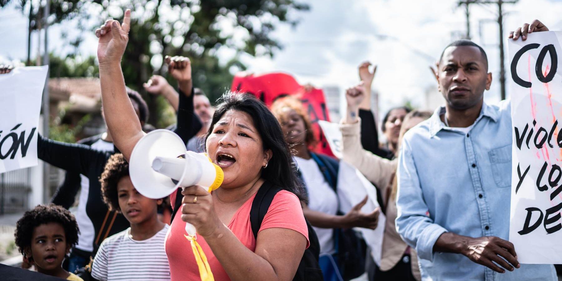 Mature woman talking in a megaphone during a protest in the street in Spain