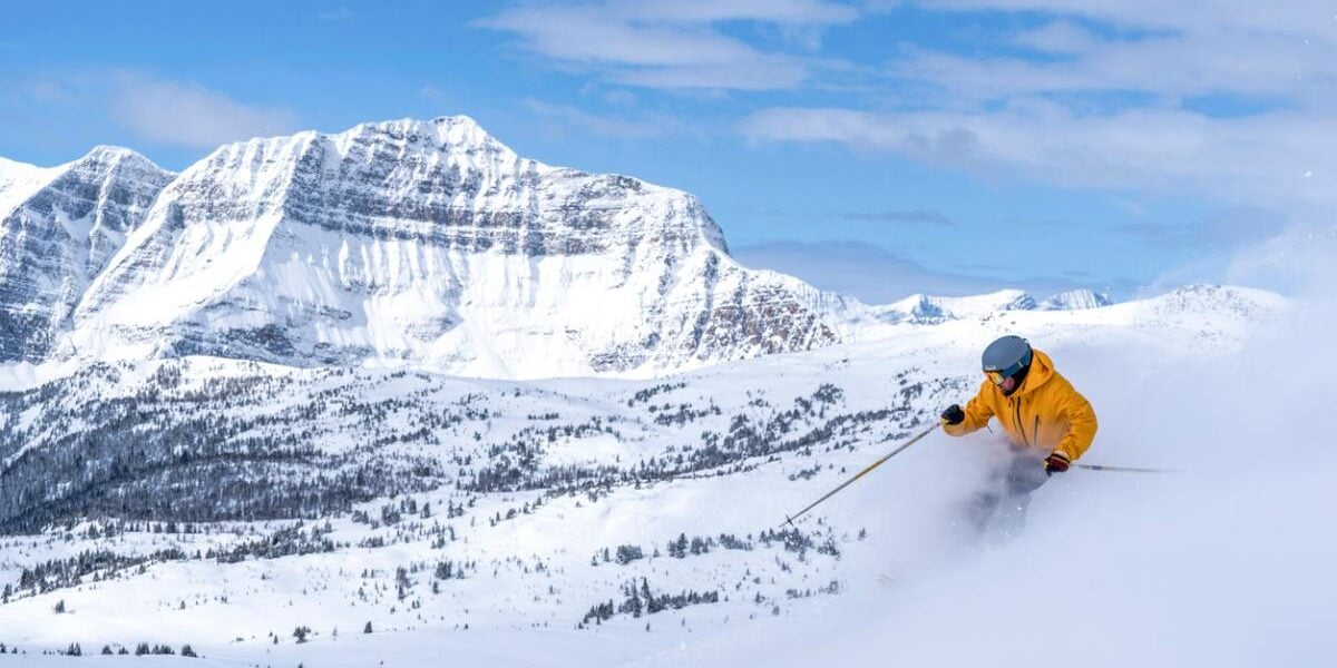 a person skiing in Alberta’s Rocky Mountain in Canada, after buying travel insurance for Canada