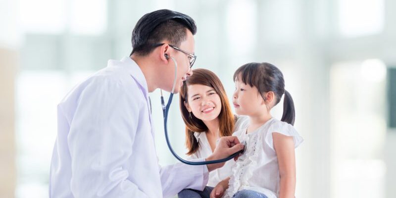 thailand doctor checking child's heartbeat